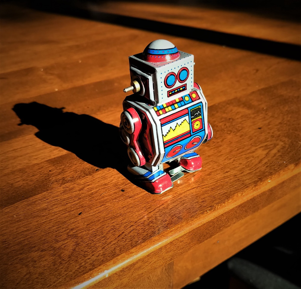 Classic wind up robot toy at the edge of a table